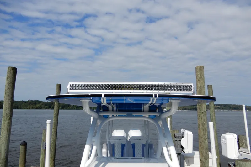 Slide: The Image of 2021 Concept 32' Open Deck boat docked by the water under a cloudy sky. - 27