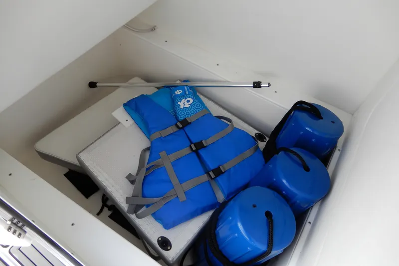 Slide: The Image of Storage compartment with blue life jacket and fenders on Concept 32' Open Deck boat. - 34