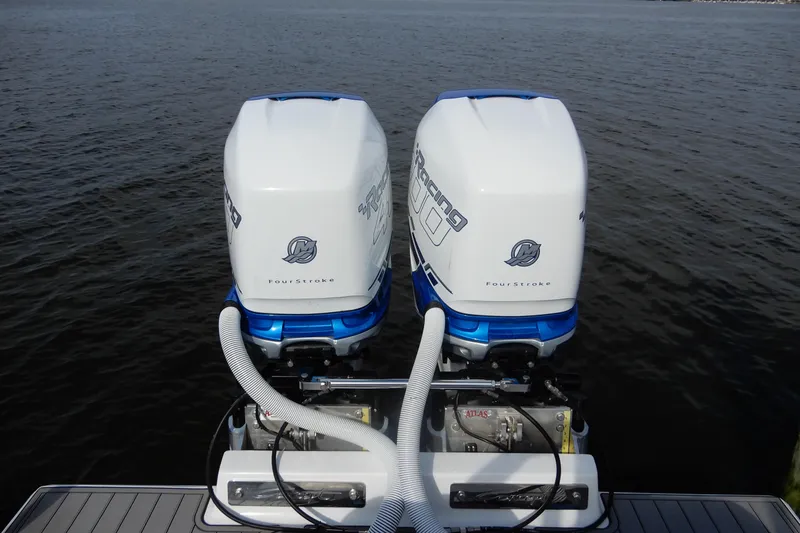 Slide: The Image of Twin outboard engines on a 2021 Concept 32' Open Deck boat, floating on calm water. - 37