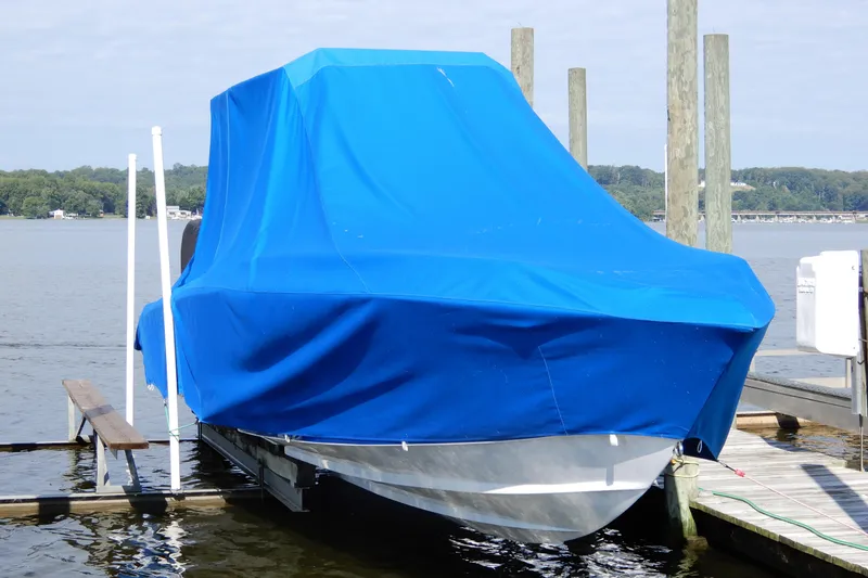 Slide: The Image of 2021 Concept 32' Open Deck boat covered with blue tarp at dockside. - 4