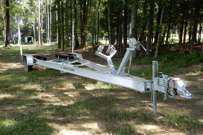 Slide: The Image of 2021 Concept 32' Open Deck trailer in a wooded area, showcasing sturdy design and construction. - 40