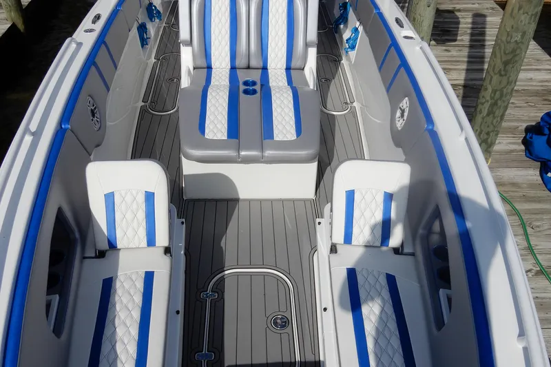 Slide: The Image of 2021 Concept 32' Open Deck boat with blue and white seating, docked on wooden pier. - 6