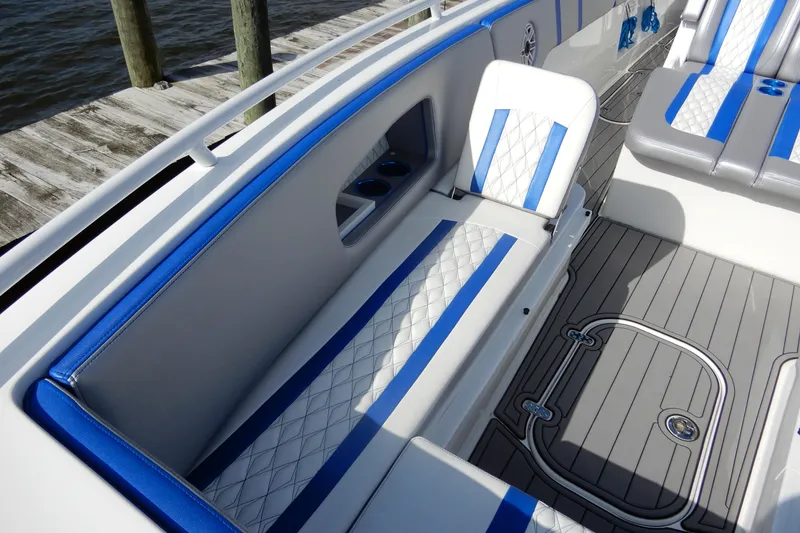 Slide: The Image of 2021 Concept 32' Open Deck boat interior with blue and white seating, dockside view. - 8
