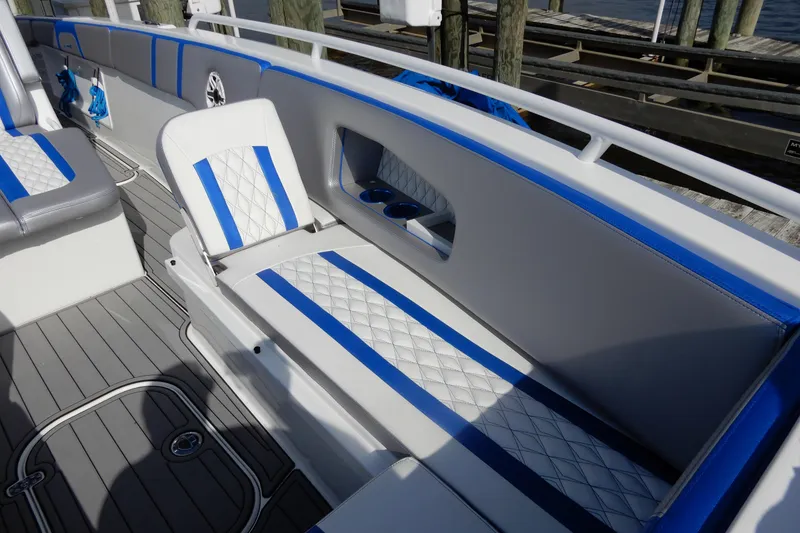 Slide: The Image of Luxurious seating on 2021 Concept 32' Open Deck boat with blue and white accents. - 9