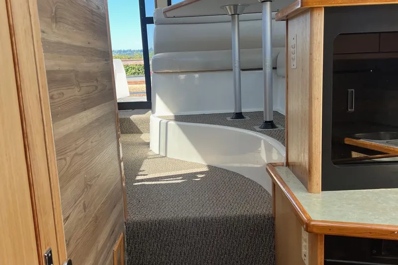 Slide: The Image of Interior view of 2000 Bayliner 3388 Command Bridge Motoryacht, featuring carpeted steps and wood accents. - 16