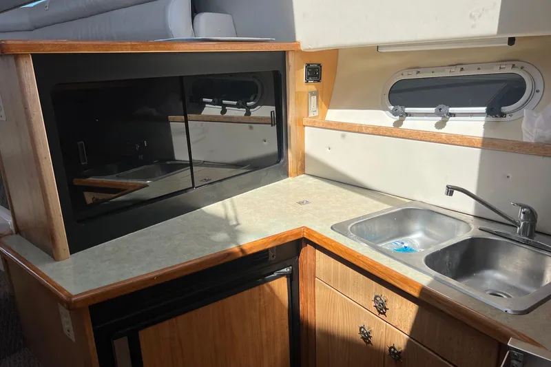 Slide: The Image of Interior of 2000 Bayliner 3388 Command Bridge Motoryacht kitchen with sink and cabinets. - 17