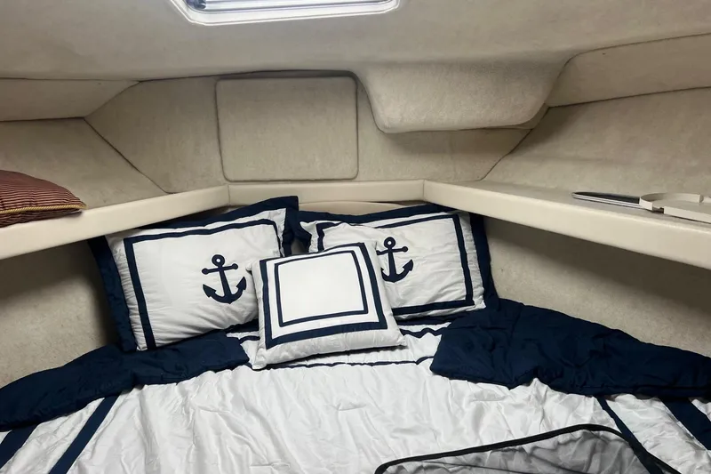 Slide: The Image of Cozy cabin interior of 2000 Bayliner 3388 Command Bridge Motoryacht with nautical-themed bedding. - 18