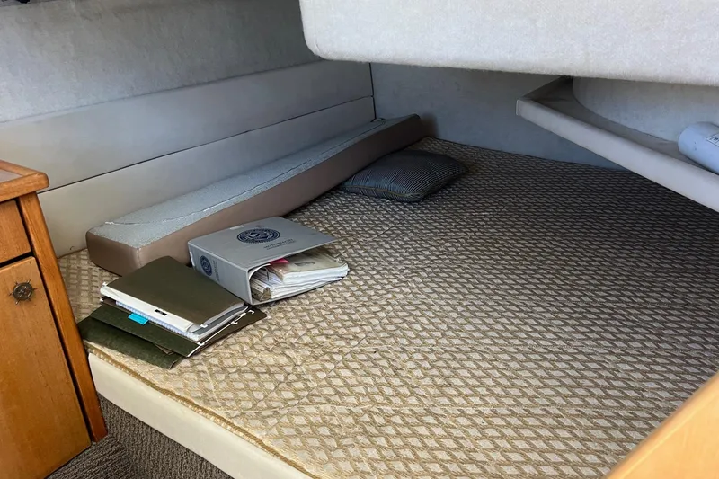 Slide: The Image of Interior cabin of 2000 Bayliner 3388 Command Bridge Motoryacht with documents and pillow. - 23