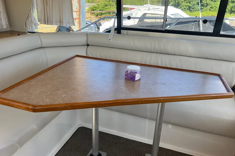 Slide: The Image of Interior of 2000 Bayliner 3388 Command Bridge Motoryacht with table and seating area. - 25