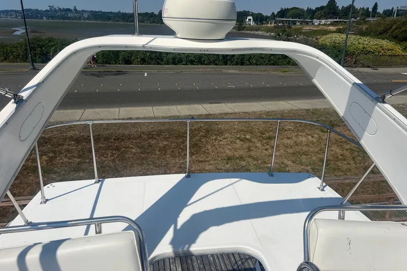Slide: The Image of 2000 Bayliner 3388 Command Bridge Motoryacht deck with scenic waterfront view. - 5