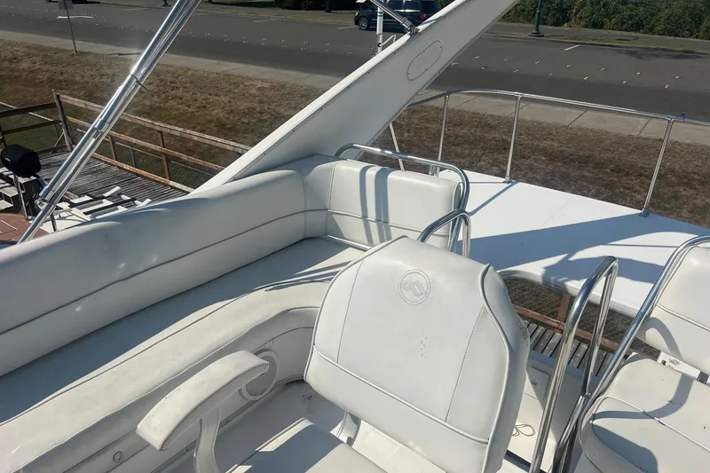 Slide: The Image of 2000 Bayliner 3388 Command Bridge Motoryacht with white seating on deck. - 6