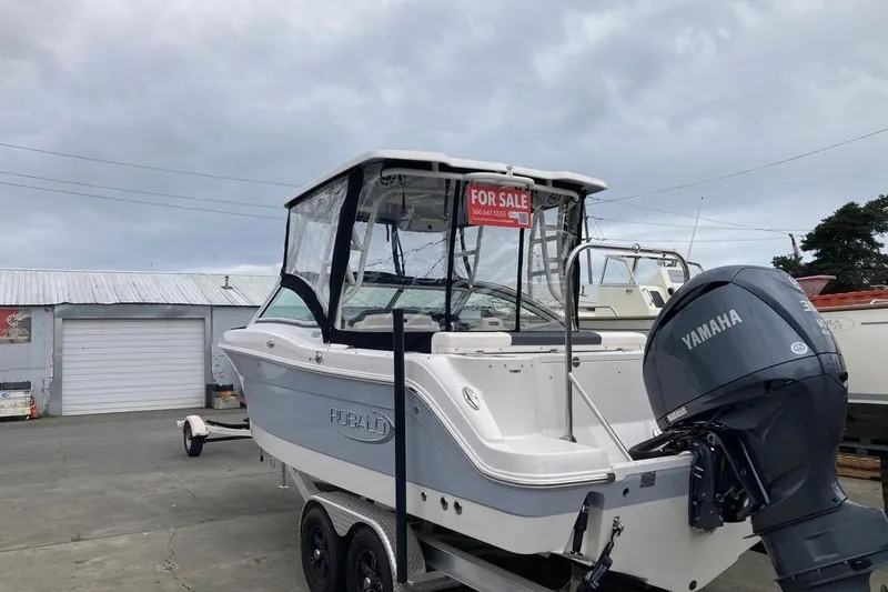 Slide: The Image of 2021 Robalo R247 Dual Console boat with Yamaha engine, for sale at a marina. - 3