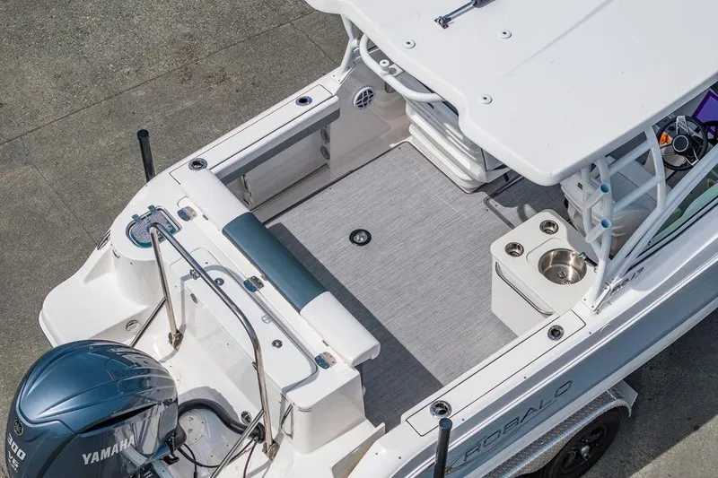 Slide: The Image of 2021 Robalo R247 Dual Console boat with Yamaha engine, featuring spacious deck and seating. - 4