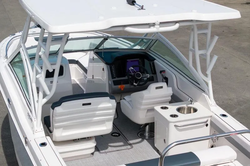 Slide: The Image of 2021 Robalo R247 Dual Console boat interior with helm, seating, and sink. - 6