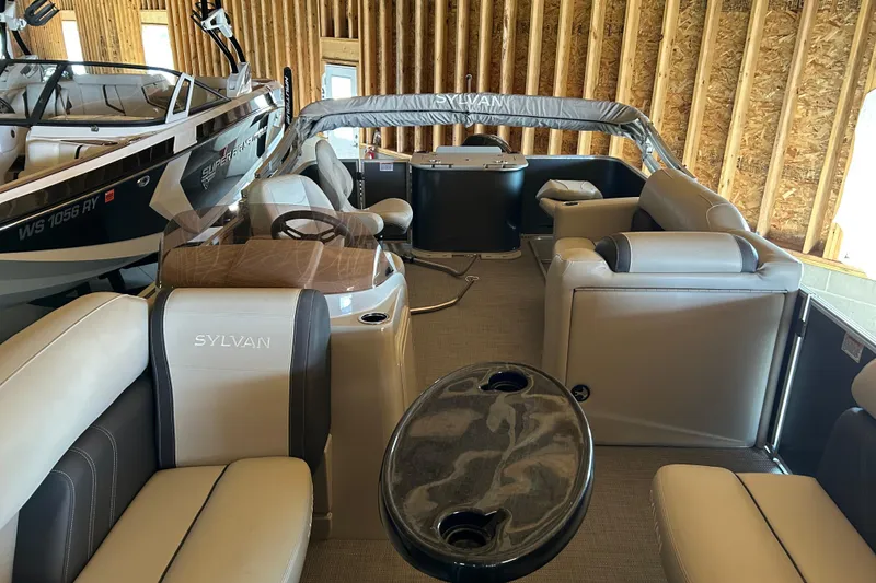 Slide: The Image of 2022 Sylvan Mirage Fish 820 Party Fish pontoon boat interior in a wooden storage area. - 7