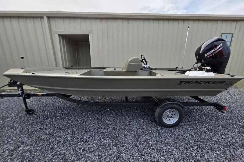 The Image of 2026 Tracker Grizzly 1648 SC boat on trailer, displayed outside a marine shop. - 0