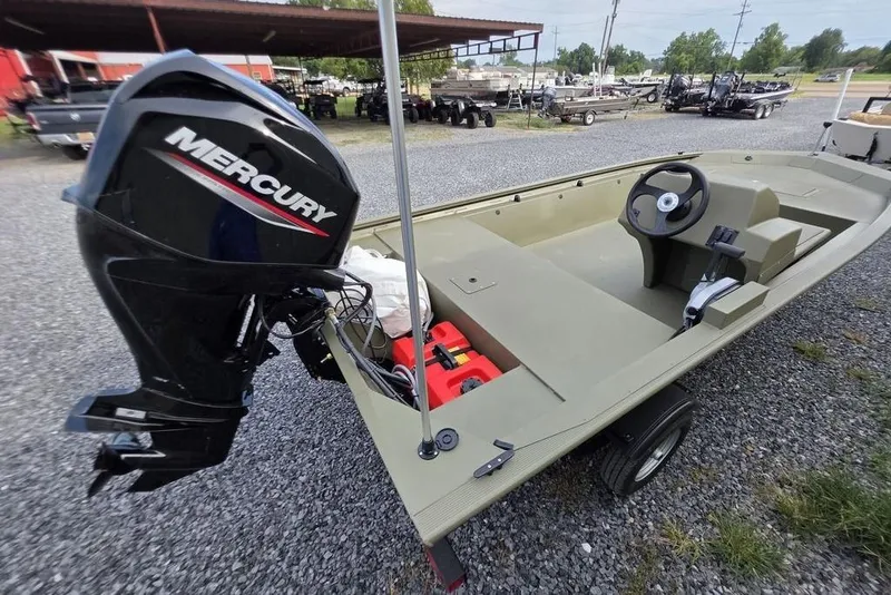 Slide: The Image of 2026 Tracker Grizzly 1648 SC boat with Mercury outboard motor on trailer. - 2