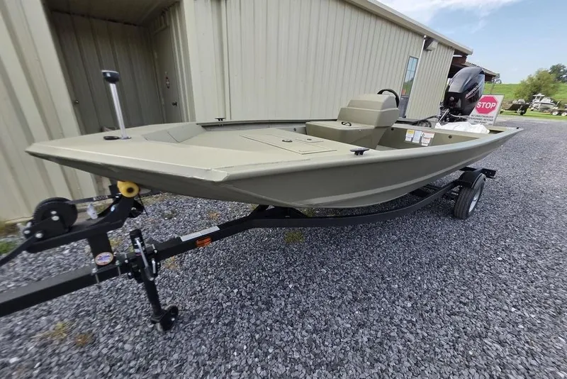 Slide: The Image of 2026 Tracker Grizzly 1648 SC boat with Mercury engine on gravel lot. - 7