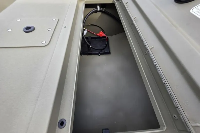 Slide: The Image of 2026 Tracker Grizzly 1648 SC boat on trailer, parked on gravel near a metal building. - 8