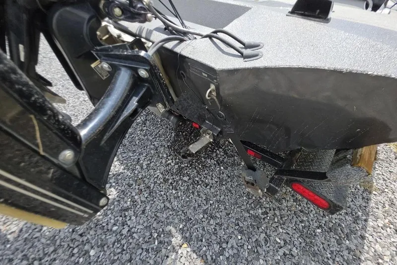 Slide: The Image of 2018 War Eagle 961 Predator boat trailer hitch and rear view on gravel. - 3