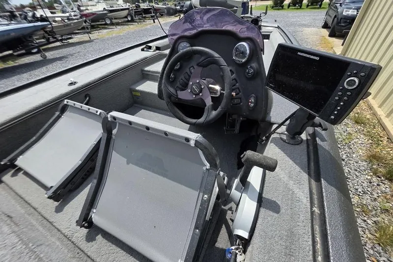 Slide: The Image of 2018 War Eagle 961 Predator boat interior with steering wheel and fish finder. - 6
