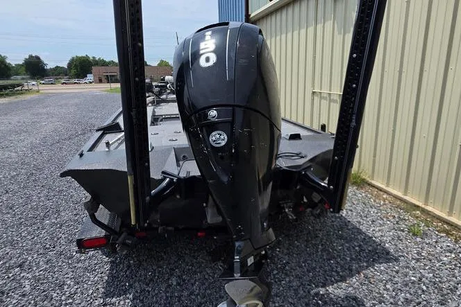 Slide: The Image of 2018 War Eagle 961 Predator boat with powerful outboard motor, parked on gravel. - 7