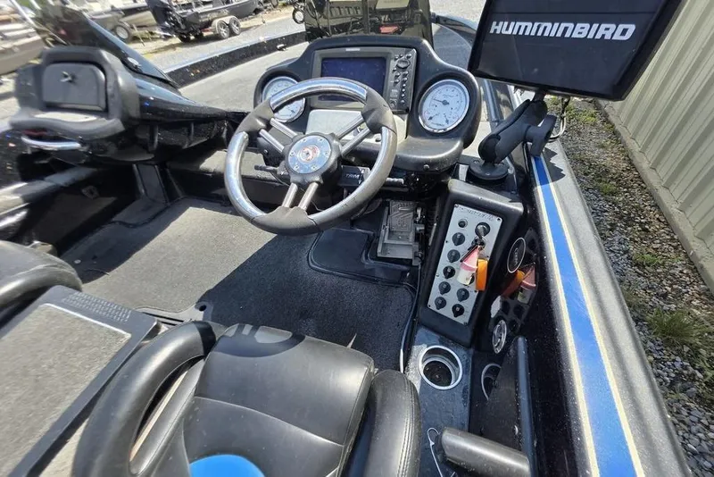 Slide: The Image of 2012 Phoenix 721 ProXP boat cockpit with steering wheel, gauges, and Humminbird electronics. - 10