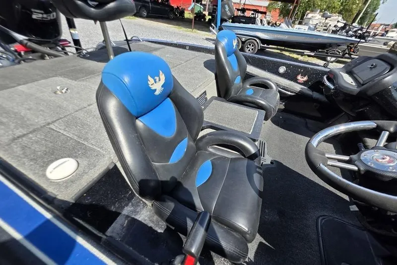 Slide: The Image of 2012 Phoenix 721 ProXP boat interior with blue and black seats, steering wheel, and dashboard. - 15