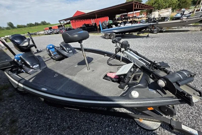 Slide: The Image of 2012 Phoenix 721 ProXP fishing boat with equipment, parked on gravel lot. - 16