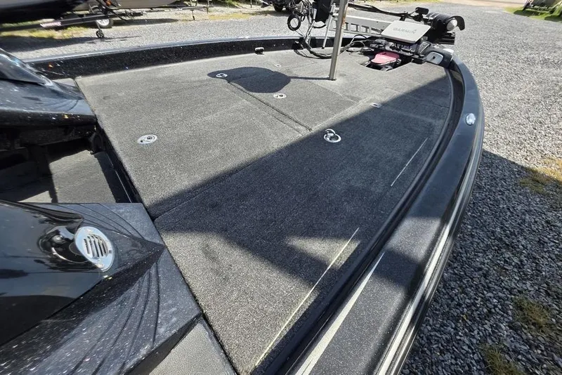 Slide: The Image of 2012 Phoenix 721 ProXP boat deck with carpeted surface and fishing equipment. - 17