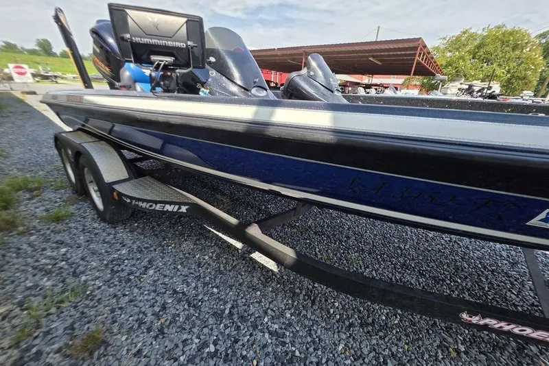 Slide: The Image of 2012 Phoenix 721 ProXP boat on trailer, featuring Humminbird electronics, parked on gravel. - 18