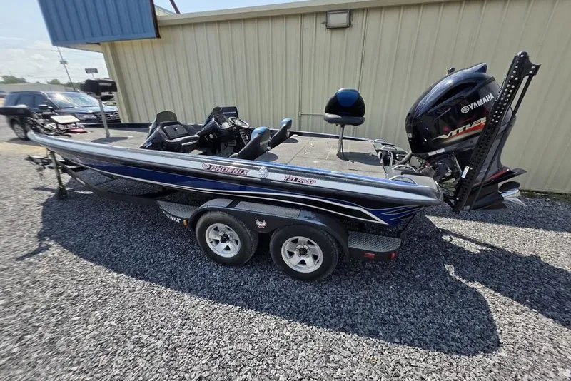 Slide: The Image of 2012 Phoenix 721 ProXP bass boat with Yamaha engine, parked on gravel. - 24