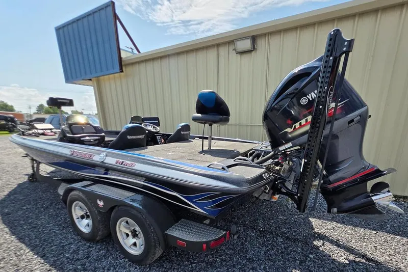 Slide: The Image of 2012 Phoenix 721 ProXP boat with Yamaha outboard motor, parked on gravel. - 4
