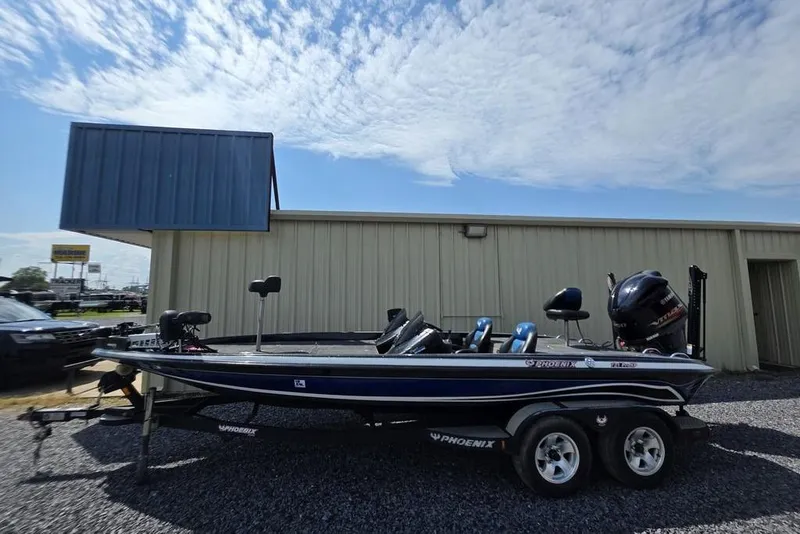 Slide: The Image of 2012 Phoenix 721 ProXP boat on trailer, parked outside a building under a blue sky. - 5