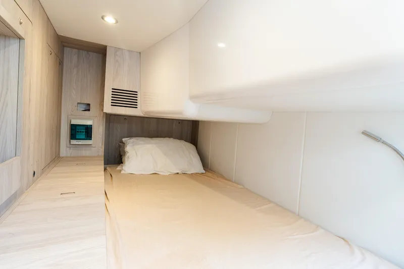 Slide: The Image of 2023 Azimut Fly 50 yacht cabin interior with modern design and cozy bedding. - 107