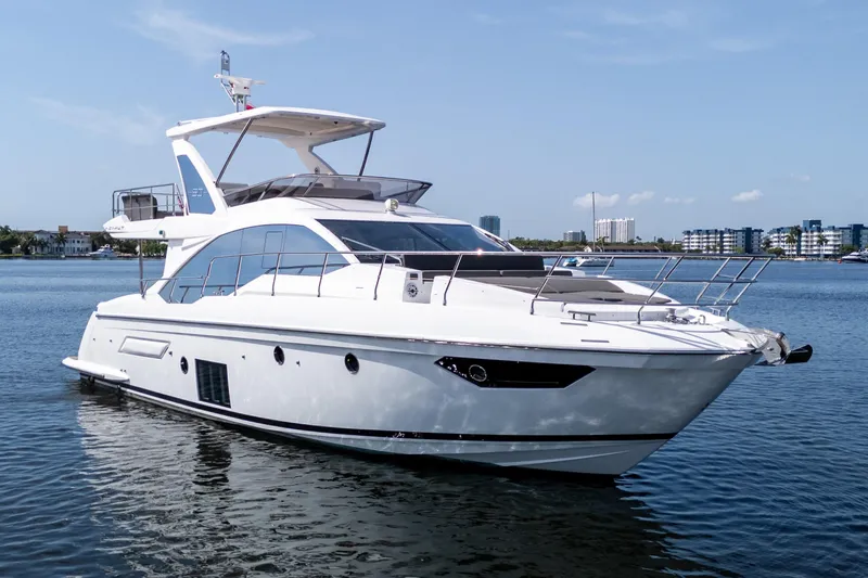 Slide: The Image of 2023 Azimut Fly 50 yacht on calm water, showcasing sleek design and luxury features. - 2