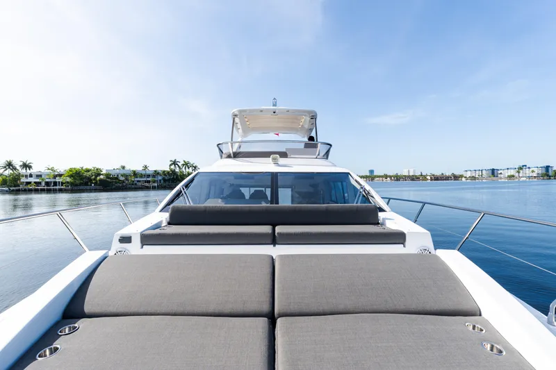 Slide: The Image of 2023 Azimut Fly 50 yacht on calm water, showcasing luxurious deck and sleek design. - 26