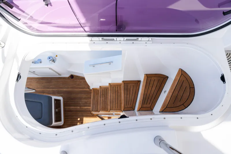 Slide: The Image of 2023 Azimut Fly 50 yacht interior with wooden steps and seating area. - 30