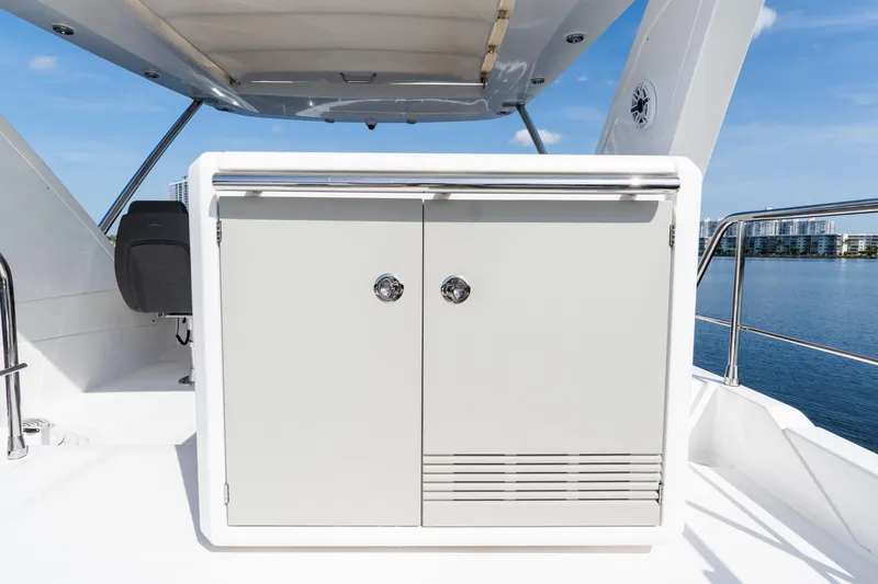 Slide: The Image of 2023 Azimut Fly 50 yacht deck with storage cabinet and scenic water view. - 35