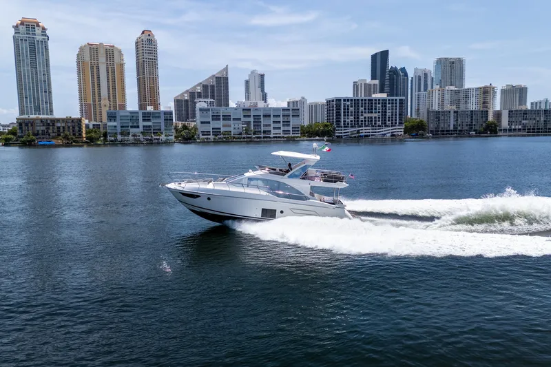Slide: The Image of 2023 Azimut Fly 50 yacht cruising near city skyline on a sunny day. - 4