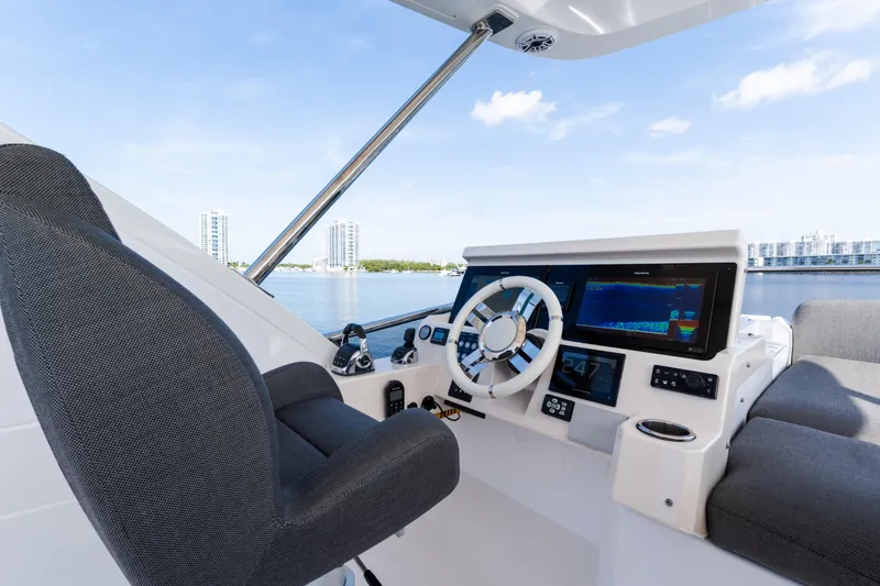 Slide: The Image of 2023 Azimut Fly 50 yacht helm with modern controls and waterfront view. - 44