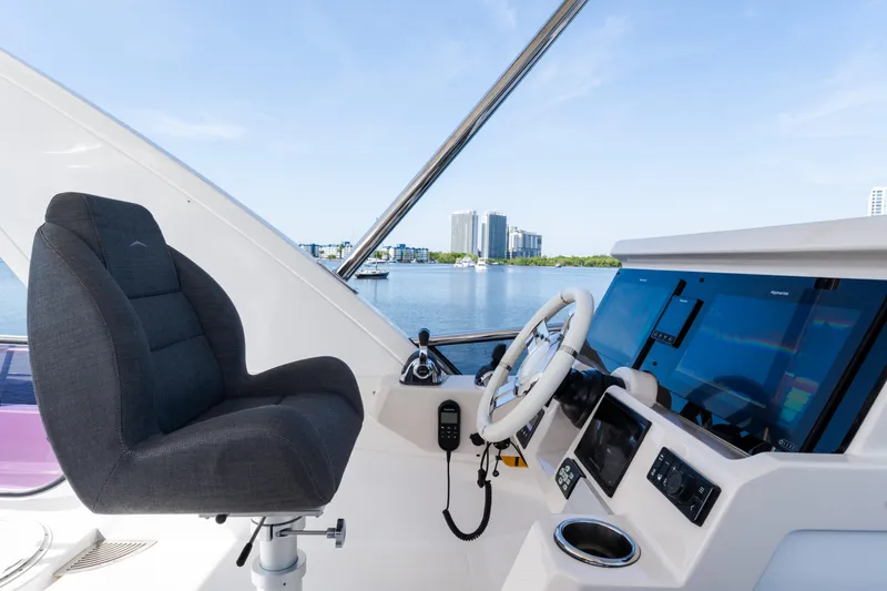 Slide: The Image of 2023 Azimut Fly 50 yacht helm with modern controls and waterfront view. - 47