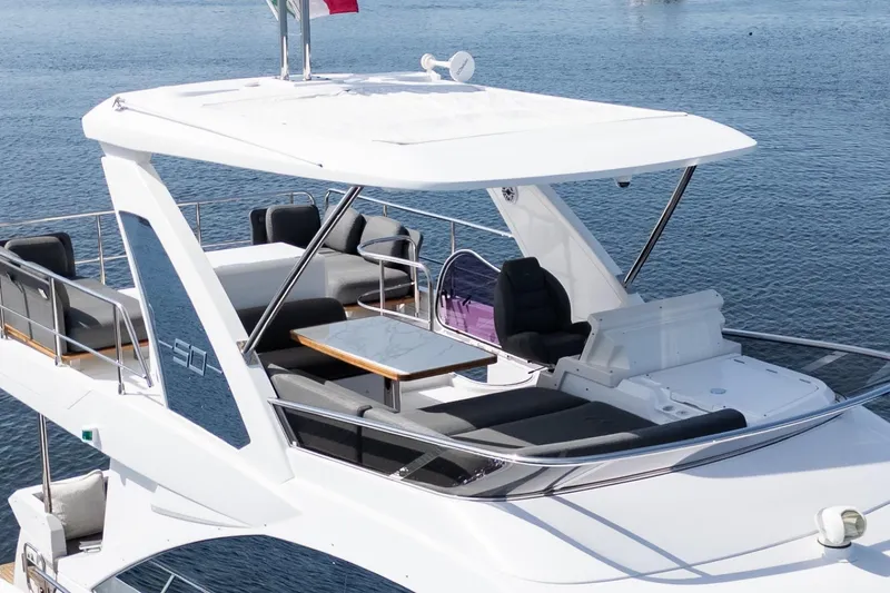 Slide: The Image of 2023 Azimut Fly 50 yacht with spacious flybridge and luxurious seating on the water. - 9