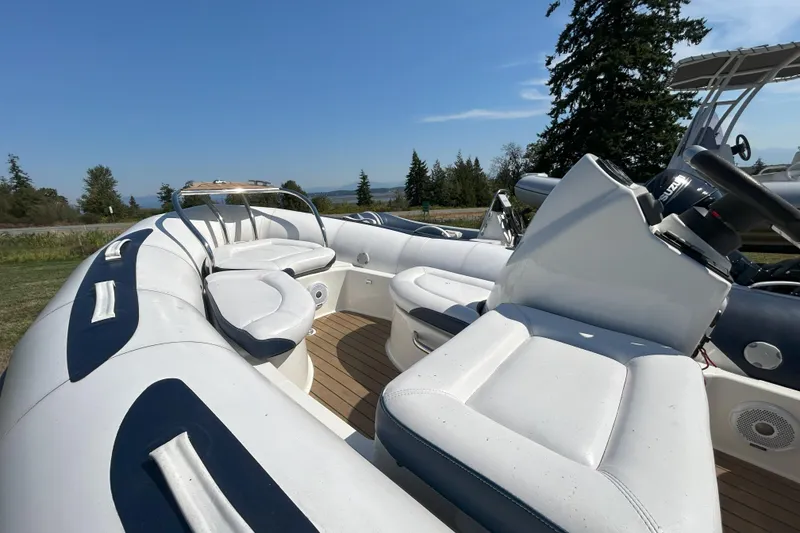 Slide: The Image of 2016 Zodiac Yachtline 420 boat interior with white seating and steering console. - 2