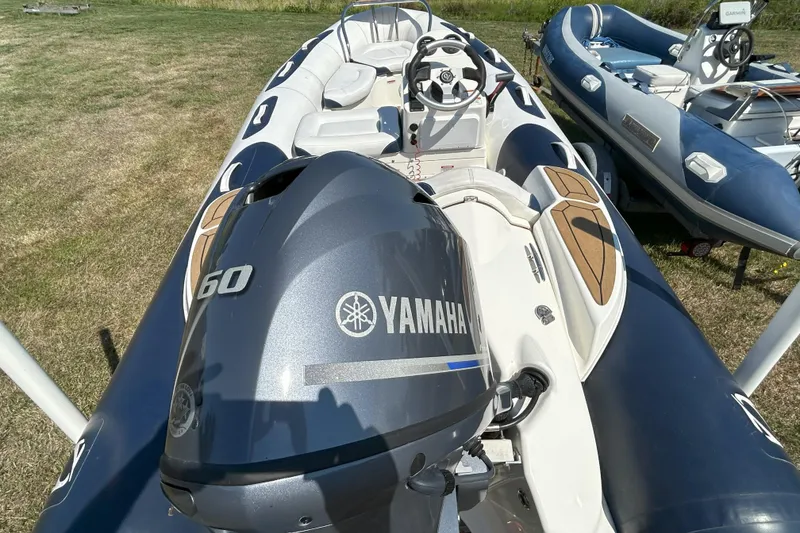 Slide: The Image of 2016 Zodiac Yachtline 420 with Yamaha 60 engine on grassy area. - 3