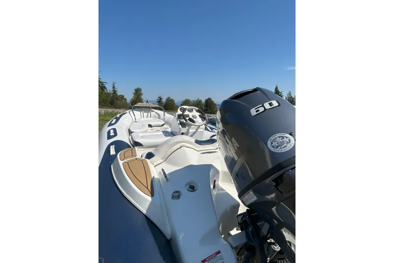 Slide: The Image of 2016 Zodiac Yachtline 420 boat with 60 HP engine, featuring sleek design and comfortable seating. - 4