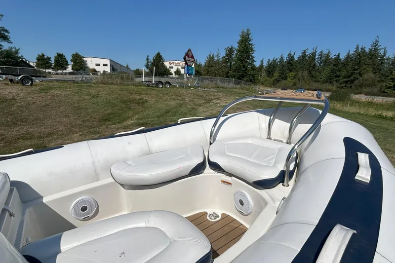 Slide: The Image of 2016 Zodiac Yachtline 420 boat interior with white seating and outdoor background. - 8