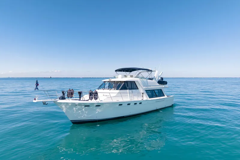 Slide: The Image of 1997 Bayliner 4788 Pilot House Motoryacht on calm blue ocean waters. - 1