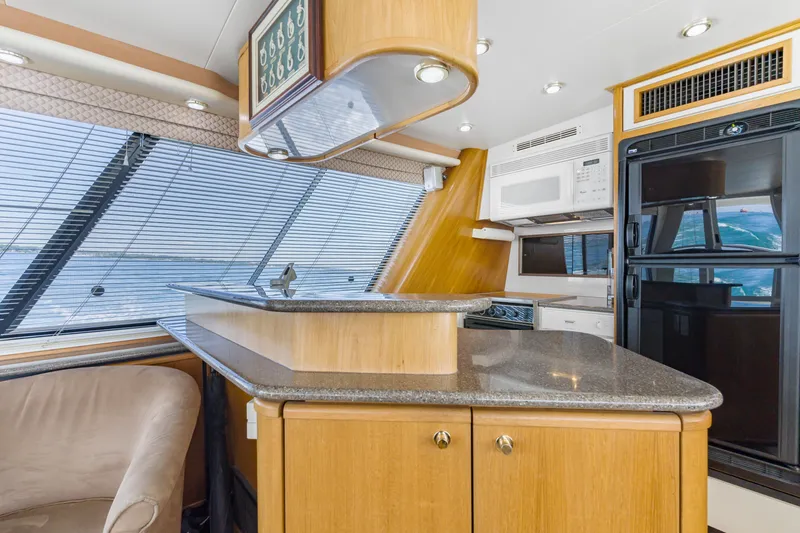 Slide: The Image of Luxurious 1997 Bayliner 4788 Pilot House Motoryacht interior with modern kitchen amenities. - 11