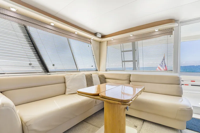 Slide: The Image of Luxurious interior of 1997 Bayliner 4788 Pilot House Motoryacht with plush seating and ocean view. - 17
